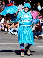 man in blue dress with parasol