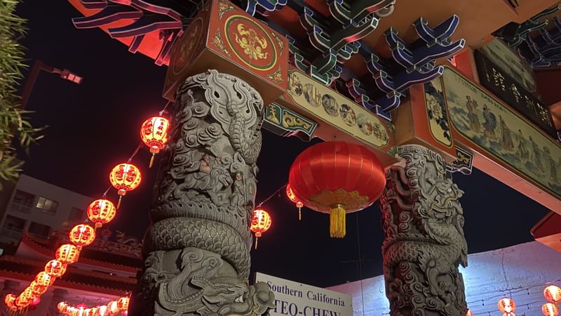 Chinese lanterns and sculptural elements outside the Two-Chew Association of Southern California, photographed at night.