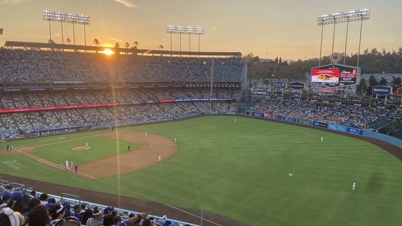 A view over the the field at Dodger Stadium from the right-side Reserve section, with the sun setting over the other side of the stadium.