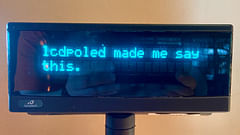 An LCD poly display with the message “lcdpoled made me say this.”